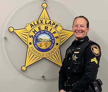 Cpl Tiffany Hedrick standing with hands crossed